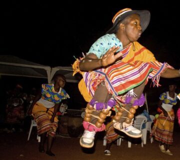 Traditional Bakisimba dance performance in Uganda, showcasing vibrant costumes, energetic movements, and rhythmic drumming 