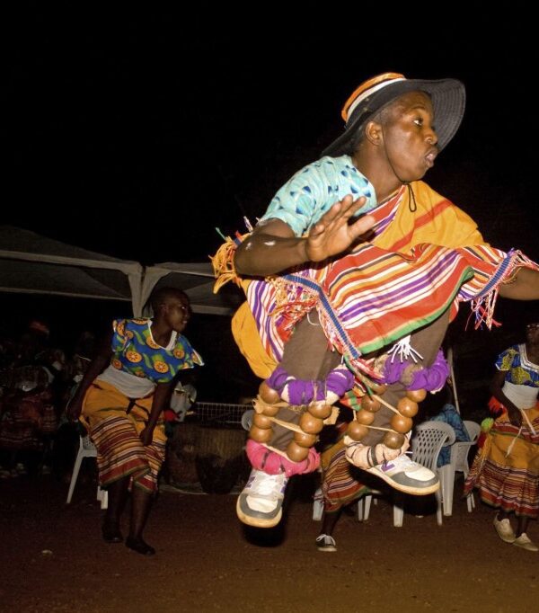 Traditional Bakisimba dance performance in Uganda, showcasing vibrant costumes, energetic movements, and rhythmic drumming.