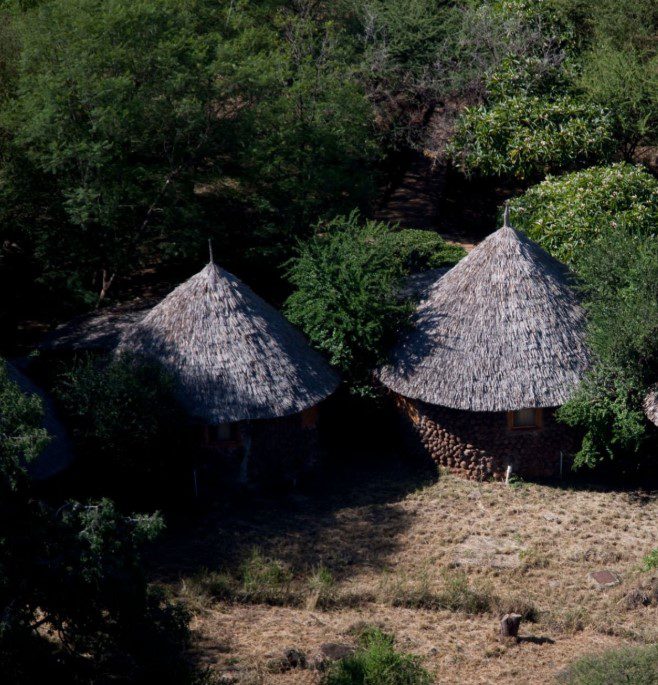 Are there Huts in Mount Kenya for Hikers? 1 Mountain huts on Mount Kenya providing shelter for hikers amid scenic alpine landscapes and rugged terrain.