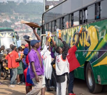 Buses on a scenic road in Uganda, showcasing safe and comfortable travel options for passengers 