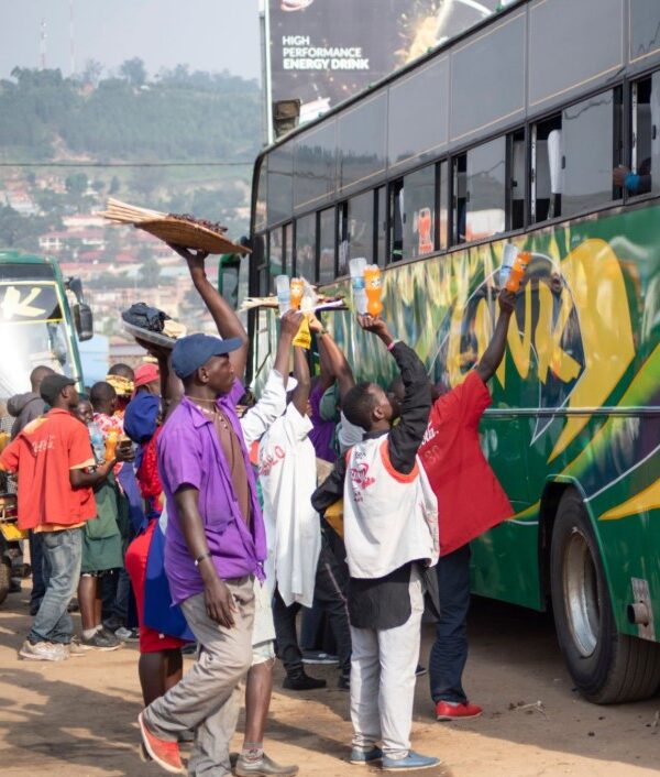 Buses on a scenic road in Uganda, showcasing safe and comfortable travel options for passengers.