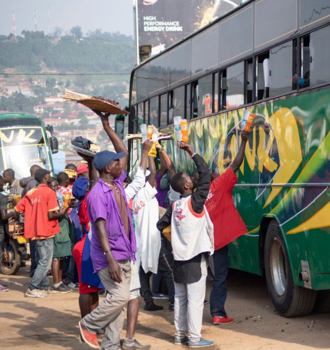 Buses on a scenic road in Uganda, showcasing safe and comfortable travel options for passengers.