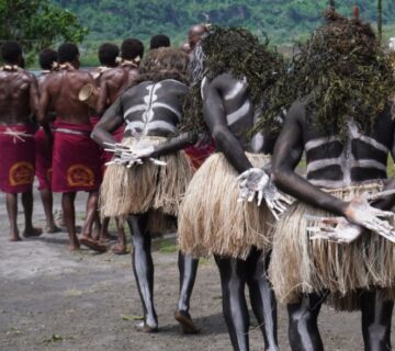 Colorful Ugandan cultural festival with traditional dancers in vibrant attire performing to rhythmic drumming and joyful community celebrations 