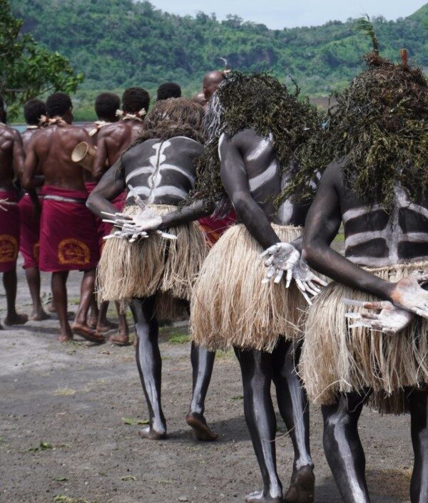 Colorful Ugandan cultural festival with traditional dancers in vibrant attire performing to rhythmic drumming and joyful community celebrations.