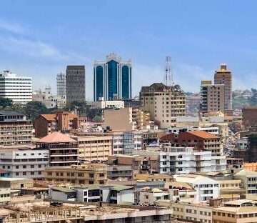 ChatGPT said: A panoramic view of Kampala city, showcasing its hills, vibrant streets, and bustling urban life 