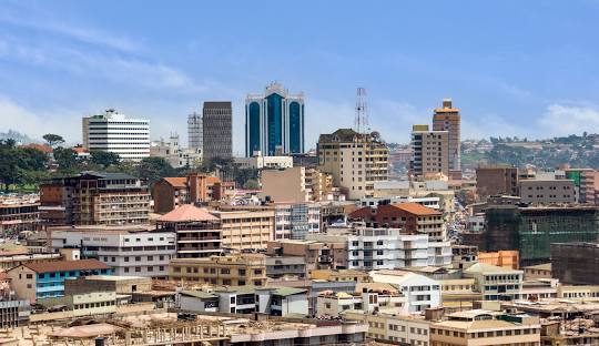ChatGPT said: A panoramic view of Kampala city, showcasing its hills, vibrant streets, and bustling urban life.