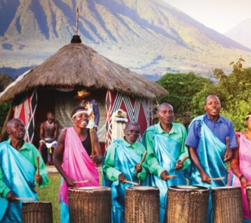 Rwandan locals engaging in traditional dance, demonstrating respect for elders, and wearing modest clothing in a vibrant cultural setting "