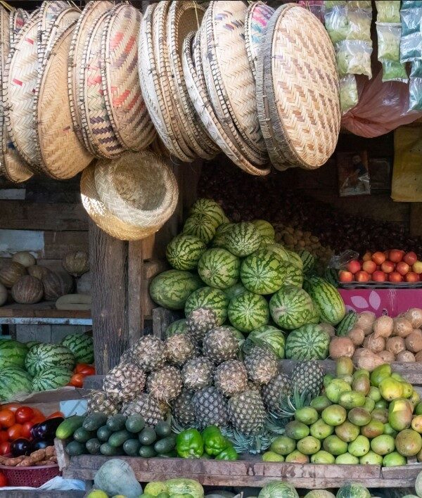 Bustling local market in Tanzania with colorful stalls and vibrant street vendors interacting with shoppers