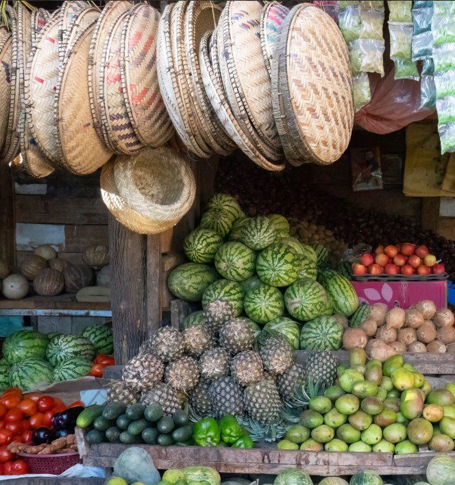 Bustling local market in Tanzania with colorful stalls and vibrant street vendors interacting with shoppers