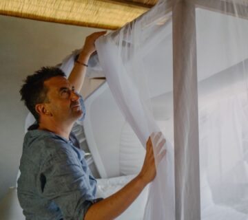 Mosquito nets providing protection against malaria during a safari, ensuring a safe and comfortable night’s sleep