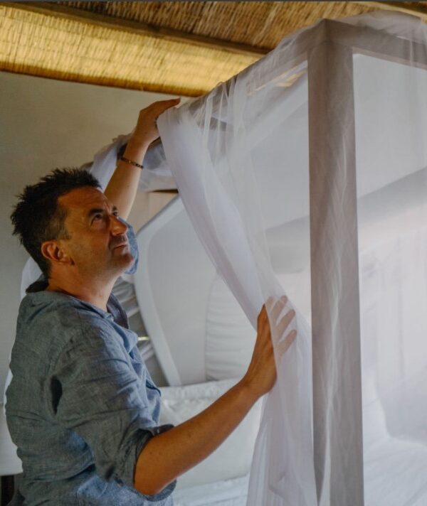 Mosquito nets providing protection against malaria during a safari, ensuring a safe and comfortable night’s sleep