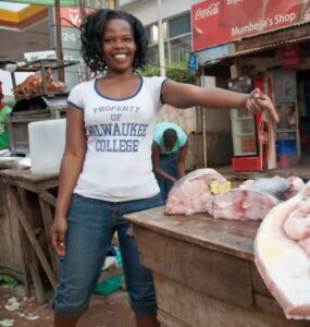 Freshly caught Nile Perch laid out for sale at a bustling local market in Uganda.
