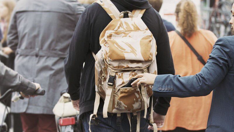 Image illustrating how to avoid pickpocketing with secure bags, awareness, and smart travel tips in crowded areas.