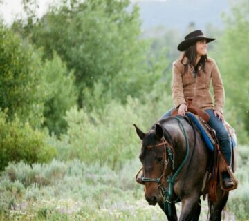 A rider on horseback exploring the African savannah during a safari 
