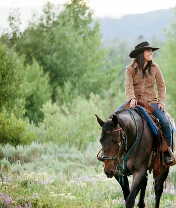 A rider on horseback exploring the African savannah during a safari.