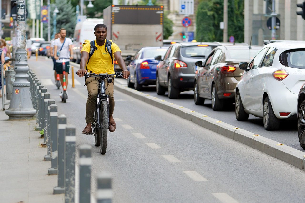 "Tourists enjoying a scenic bike ride through a vibrant city, exploring local landmarks and experiencing the culture on two wheels
