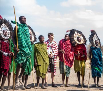 Traditional Tanzanian performers in Arusha dancing in colorful attire during a cultural celebration 
