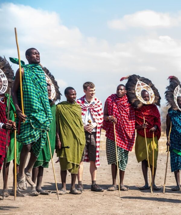 Traditional Tanzanian performers in Arusha dancing in colorful attire during a cultural celebration.