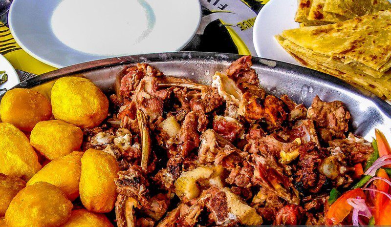 A delicious plate of Nyama Choma, showcasing perfectly roasted meat served with traditional Kenyan sides.