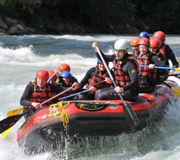 A group of adventurers white water rafting through powerful rapids on the Nile River in Jinja, Uganda 