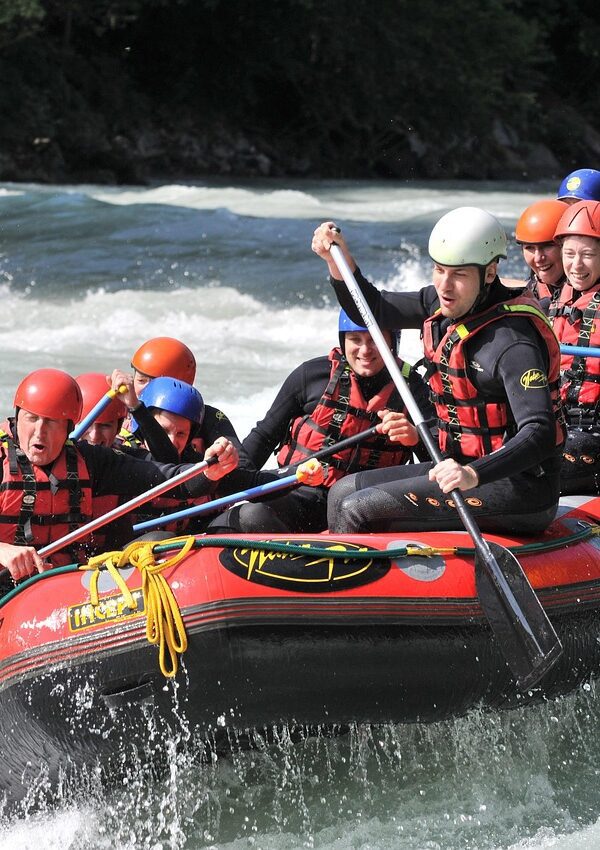 A group of adventurers white-water rafting through powerful rapids on the Nile River in Jinja, Uganda.