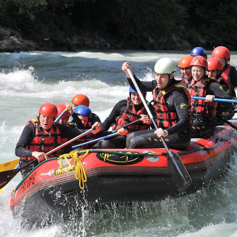 A group of adventurers white-water rafting through powerful rapids on the Nile River in Jinja, Uganda.