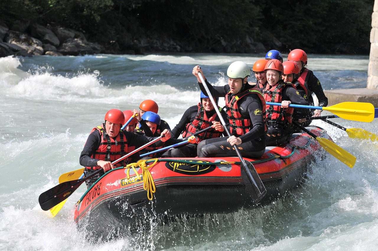 A group of adventurers white-water rafting through powerful rapids on the Nile River in Jinja, Uganda.