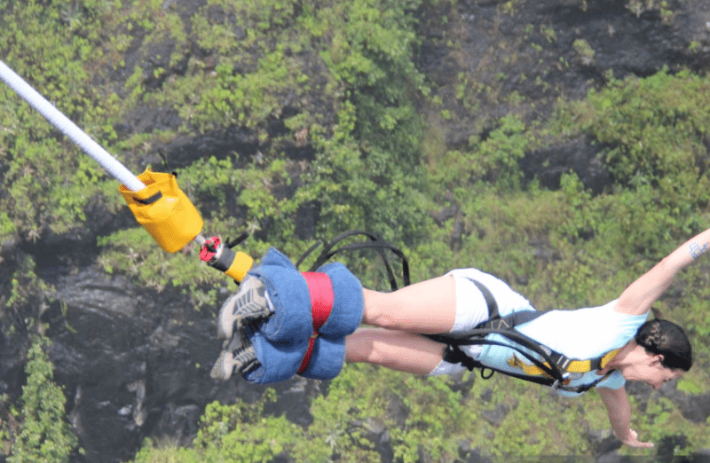 rafting-with-bungee-jumping Adventurer rafting wild Nile rapids before bungee jumping from Uganda's 44m platform