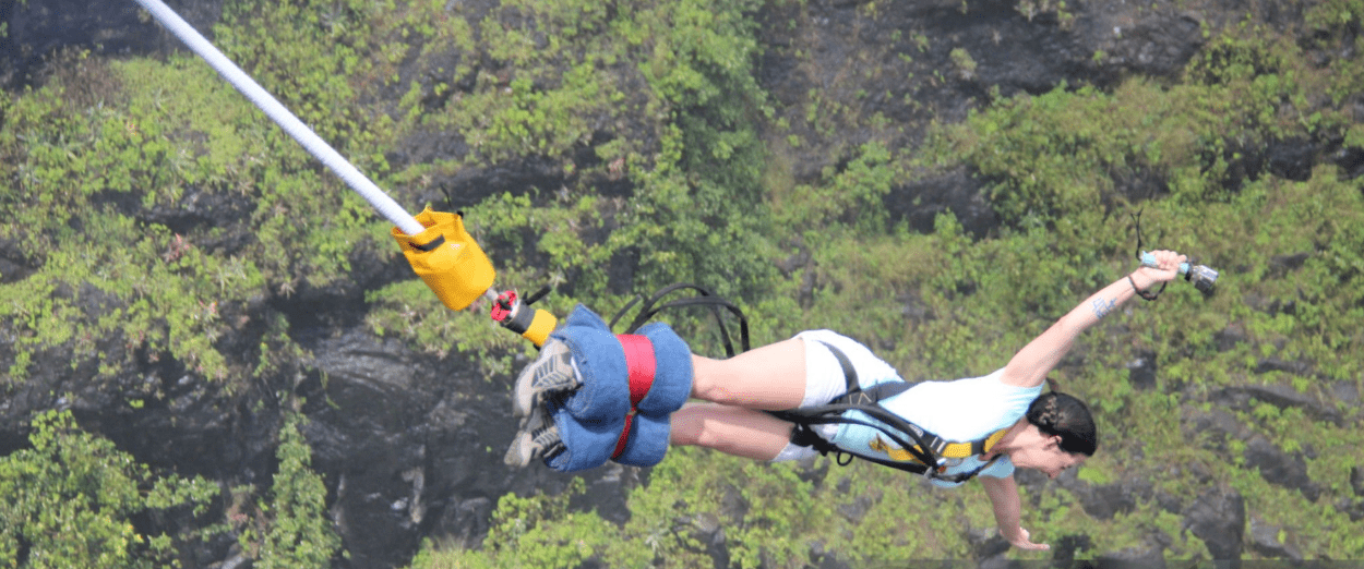 Adventurer rafting wild Nile rapids before bungee jumping from Uganda's 44m platform
