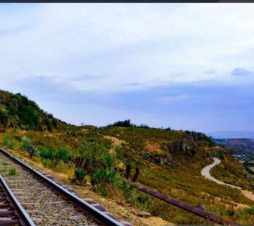 Train traveling through scenic landscapes in Kenya, showcasing beautiful views along the country's railway routes