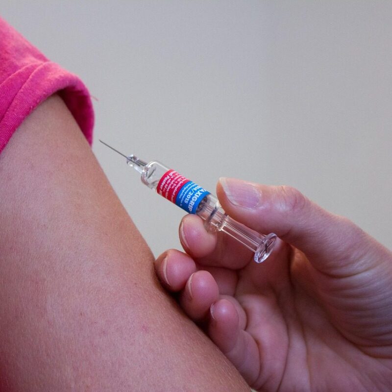 Woman receiving vaccination shot before traveling to Tanzania