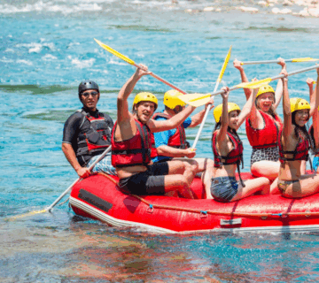 Women-only rafting group conquering Tanzania's wild rapids with teamwork and adventure spirit. Group Safari Planning Guide