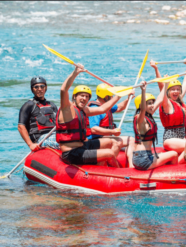 Women-only rafting group conquering Tanzania's wild rapids with teamwork and adventure spirit. Group Safari Planning Guide