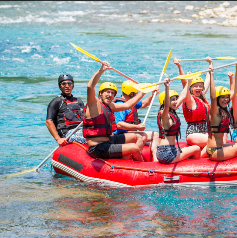 Women-only rafting group conquering Tanzania's wild rapids with teamwork and adventure spirit. Group Safari Planning Guide