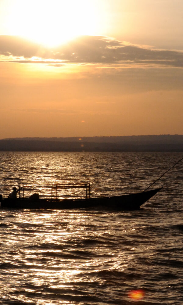 Fisherman at sunset, best shore fishing spots in Tanzania