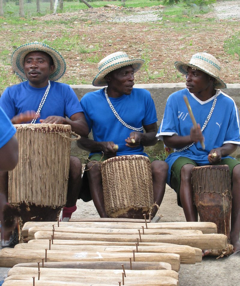 Traditional drummers performing during a Ugandan cultural village tour