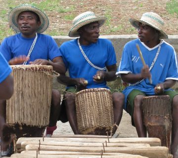 Traditional drummers performing during a cultural village tour