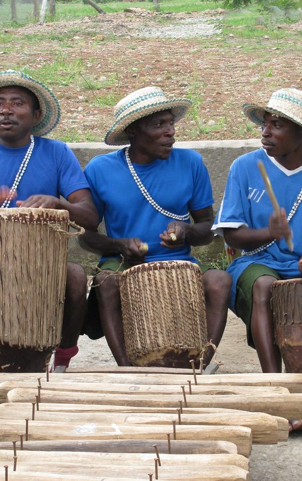 Traditional drummers performing during a cultural village tour