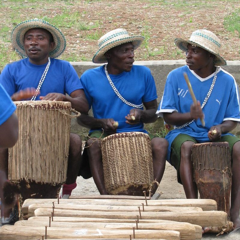 Traditional drummers performing during a cultural village tour