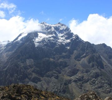Snow capped glacial peak of the Rwenzori Mountains against a blue sky