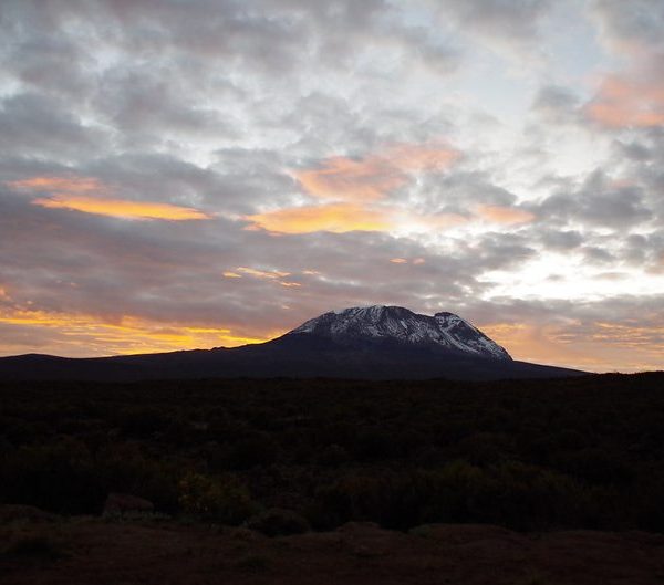 Mount Kilimanjaro silhouetted at sunrise, Tanzania, the genuine location for Kilimanjaro climbing