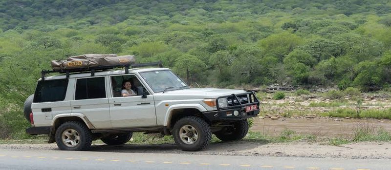 A four wheel drive self drive safari vehicle parked along a rural road