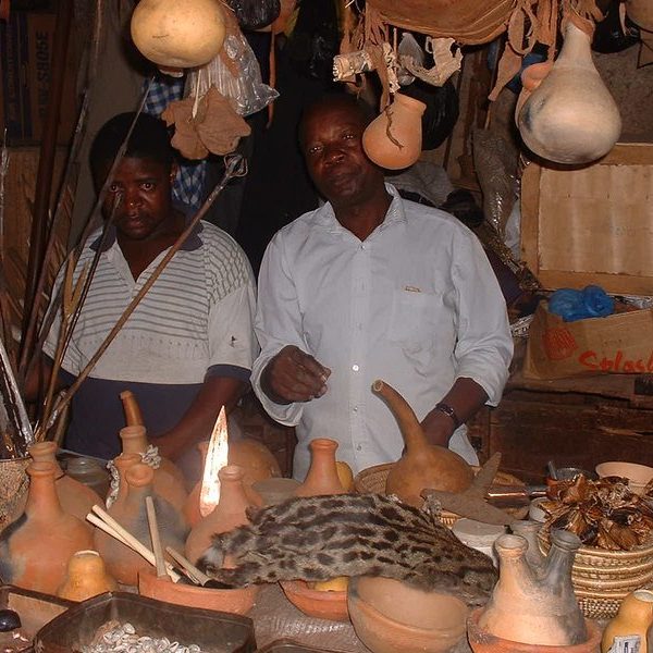Local artisans at a traditional Ugandan craft market with handmade pottery and goods