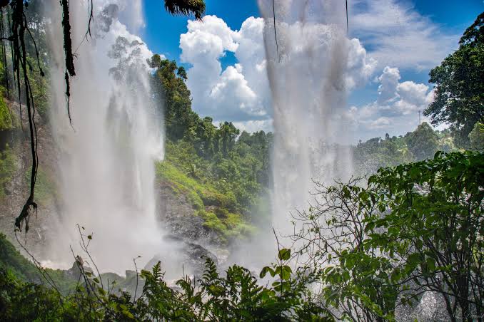 Powerful white water rapids flowing between rocky islands at Itanda Falls near Jinja in eastern Uganda