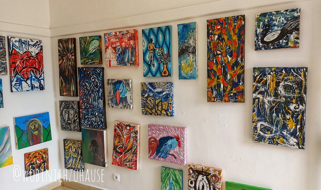 Andan contemporary artist working on a colourful canvas at Inema Arts Center in Kigali