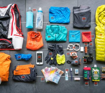 Refillable water bottle, fabric laundry bag and reusable travel organisers packed for a sustainable Rwanda safari 