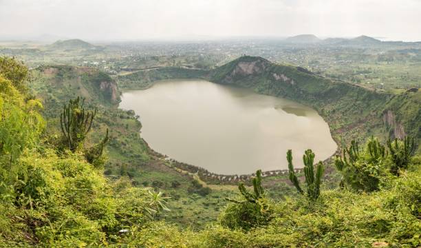 Beautiful Lake Mutanda surrounded by green hills with the Virunga Volcanoes rising in the distance near Kisoro, Uganda