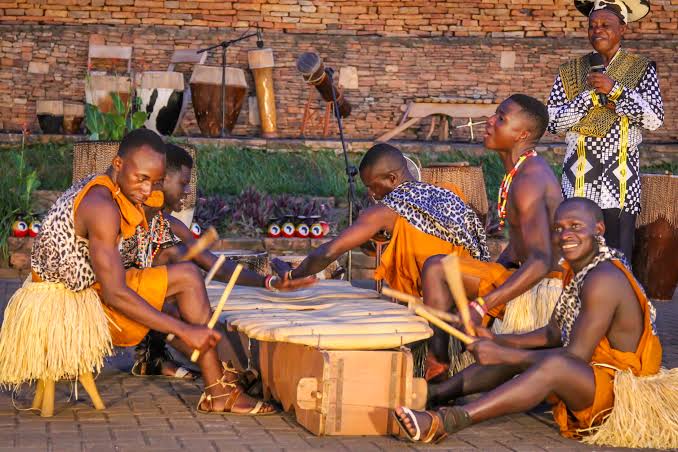 Ugandan cultural dancers performing in colourful traditional costumes during an evening show at Ndere Cultural Centre in Kampala