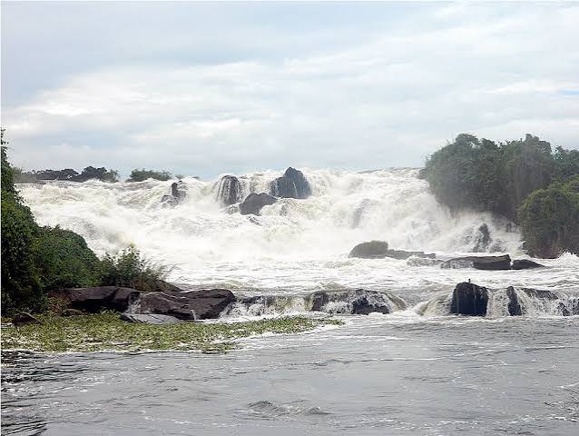 Aruma Bridge crossing the Victoria Nile beside rocky river scenery in northern Uganda